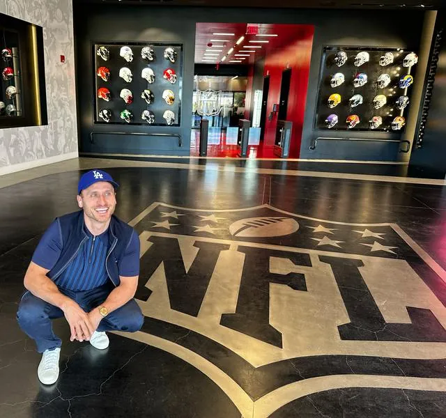 Me crouching on the NFL shield logo inlaid in a lobby floor