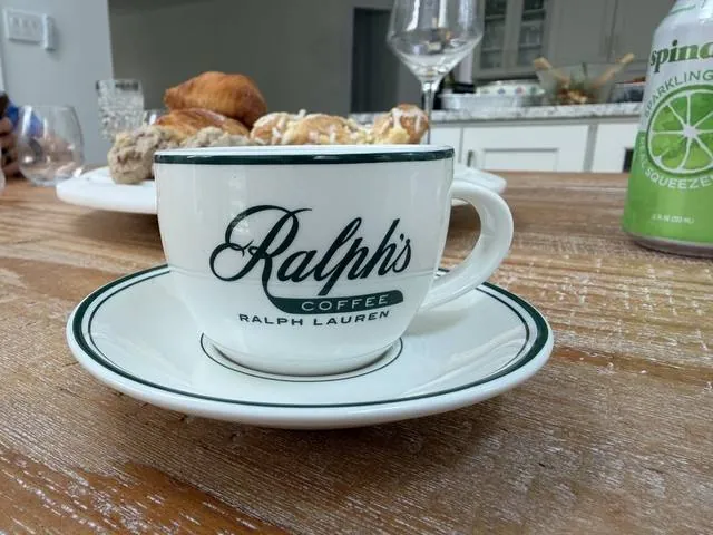 A Ralph's Coffee cup and saucer on a kitchen counter