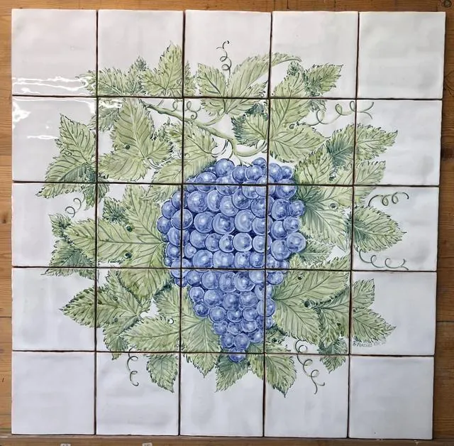 A hand painted tile panel of a bunch of grapes