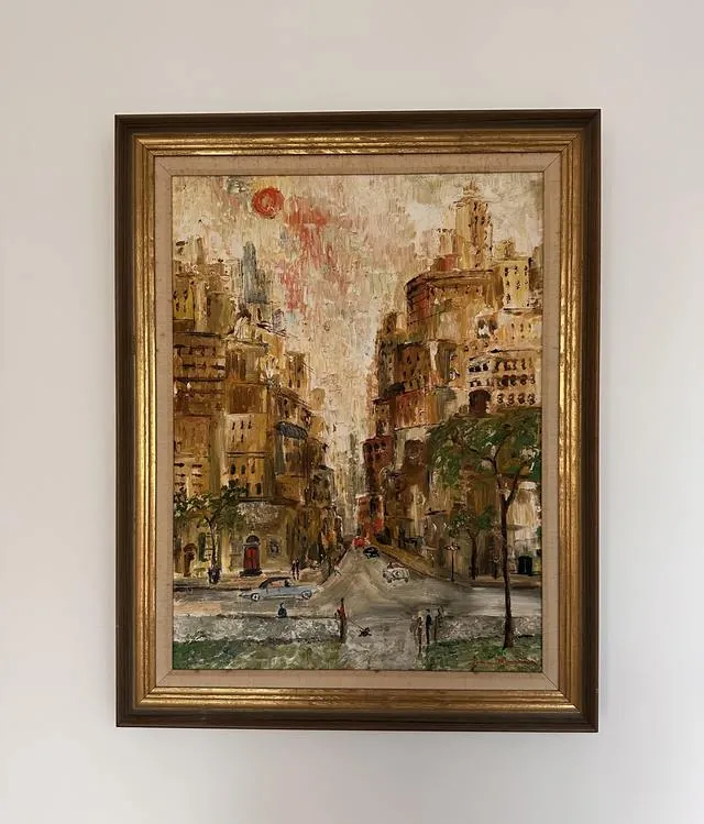 A framed impressionist painting of a New York street